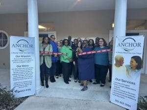 ANCHOR Ribbon Cutting, featuring group of people. Elder Options Board Members, Advisory Board Members and Staff stand along side CEO, Katina Mustipher.