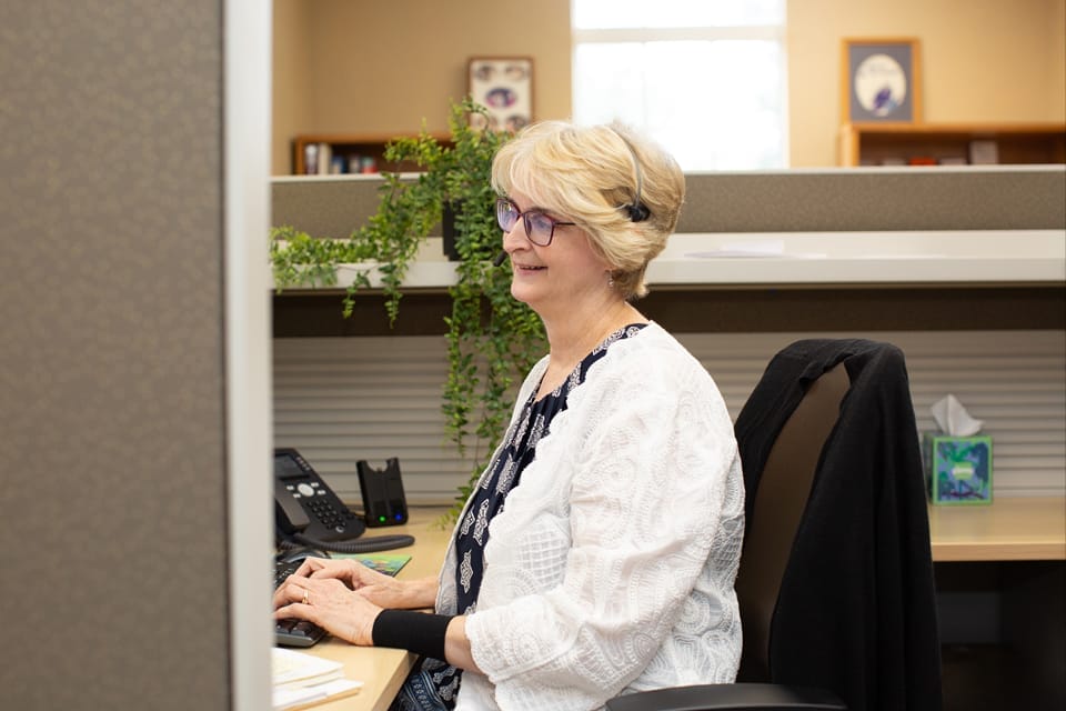 Woman taking calls from the help line