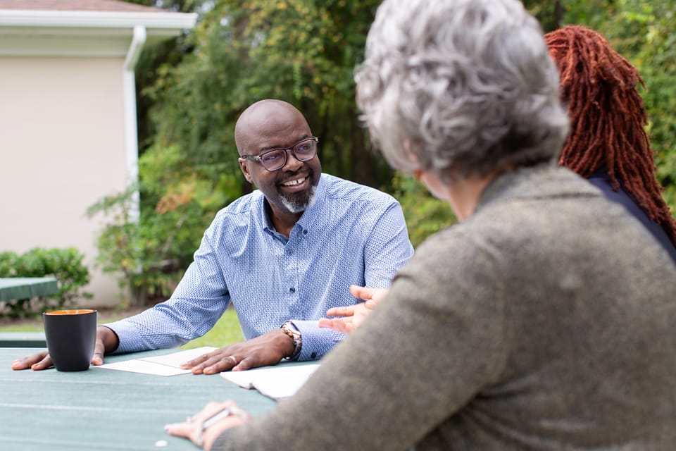 Elder Options employee speaking to clients about caregiver support