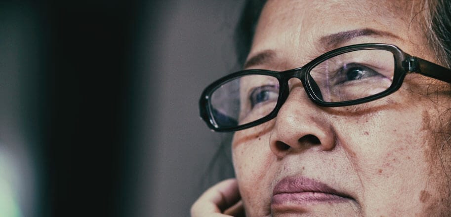 Elder woman looking off sadly thinking about abuse